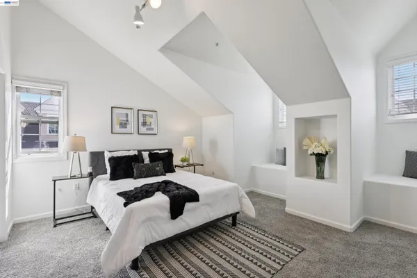 a bedroom with a bed and a large window