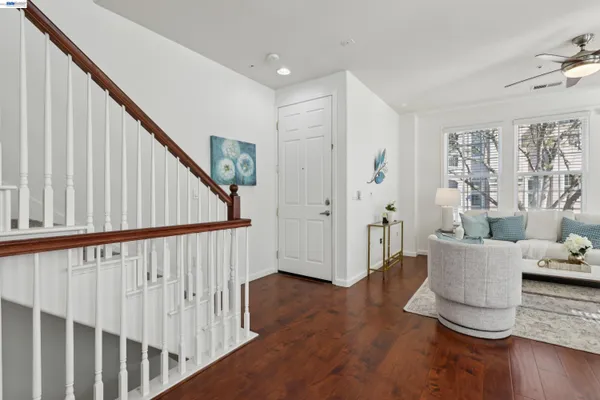 a view of a livingroom with wooden floor and stairs