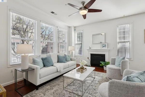 a living room with furniture a large window and a fireplace