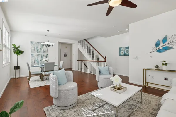 a living room with furniture and view of wooden floor