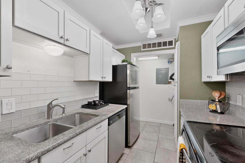 8404 Forest Lane, Unit 1305 Dallas, TX 75243 - Photo 15 of 32 a kitchen with stainless steel appliances granite countertop a sink stove and refrigerator
