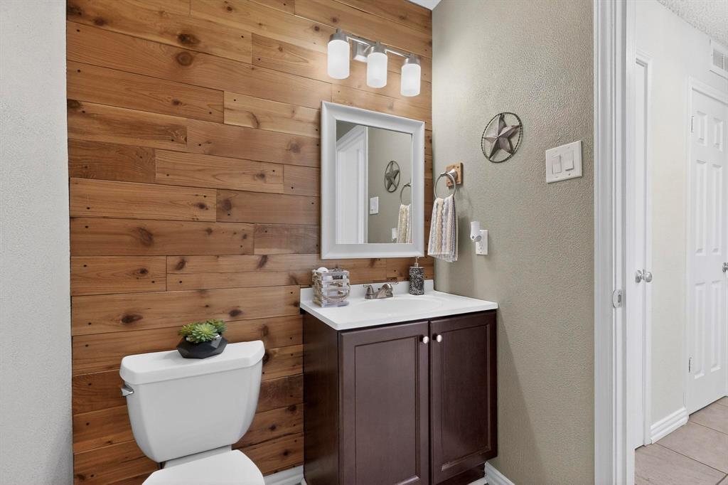 8404 Forest Lane, Unit 1305 Dallas, TX 75243 - Photo 17 of 32 a bathroom with a toilet sink and mirror