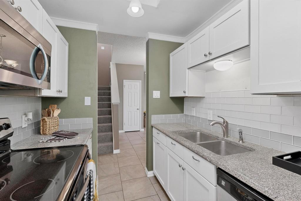 8404 Forest Lane, Unit 1305 Dallas, TX 75243 - Photo 2 of 32 a kitchen with stainless steel appliances granite countertop a sink stove and refrigerator