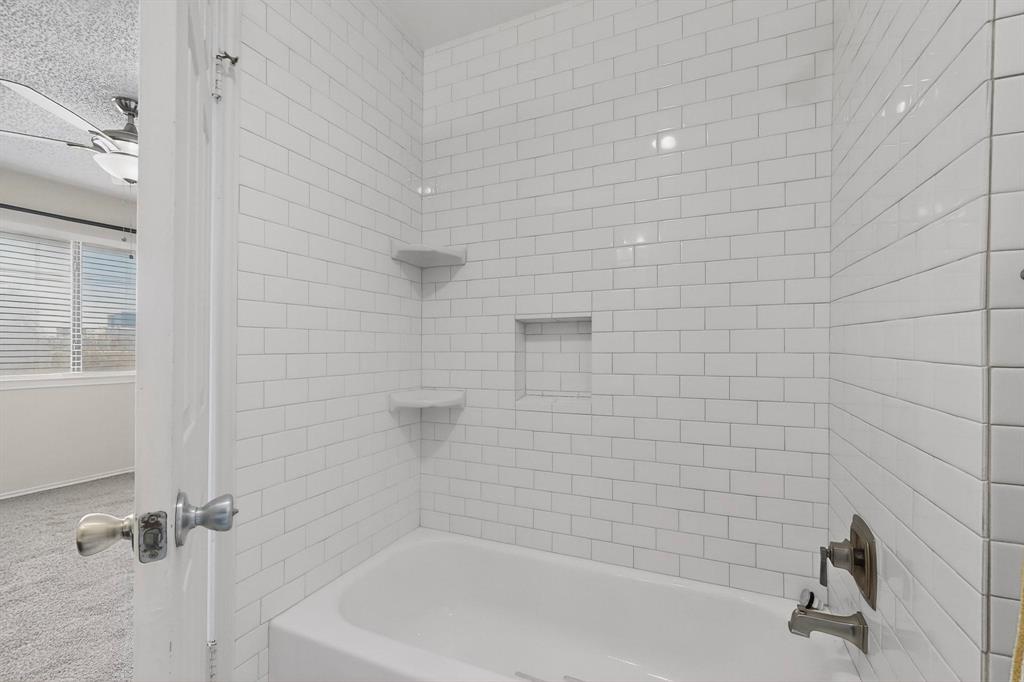 8404 Forest Lane, Unit 1305 Dallas, TX 75243 - Photo 21 of 32 a bathroom with a bathtub
