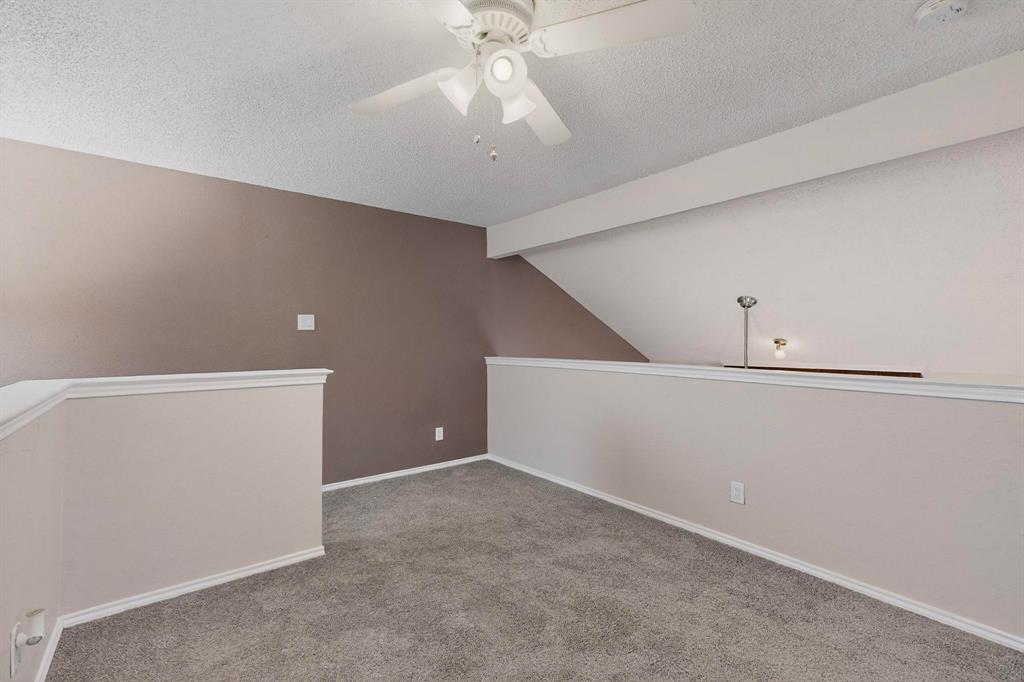 8404 Forest Lane, Unit 1305 Dallas, TX 75243 - Photo 22 of 32 a view of an empty room with a ceiling fan