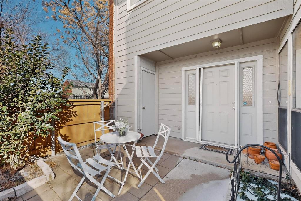 8404 Forest Lane, Unit 1305 Dallas, TX 75243 - Photo 3 of 32 a patio with table and chairs and potted plants