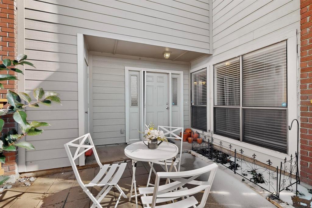 8404 Forest Lane, Unit 1305 Dallas, TX 75243 - Photo 6 of 32 a view of a patio with table and chairs with potted plants