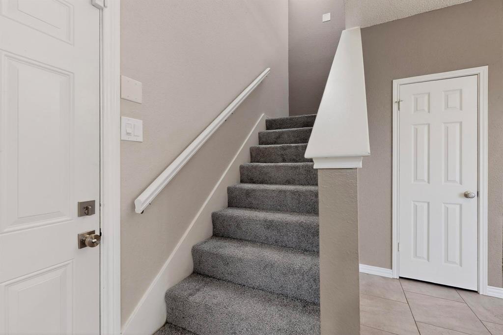 8404 Forest Lane, Unit 1305 Dallas, TX 75243 - Photo 8 of 32 a view of staircase with white walls and white door