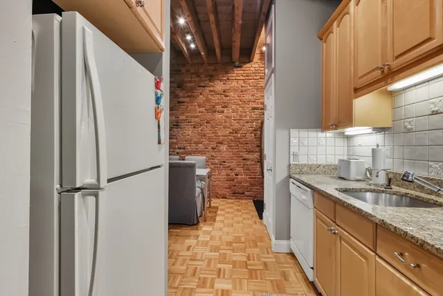 a bathroom with a granite countertop shower a sink and a stove