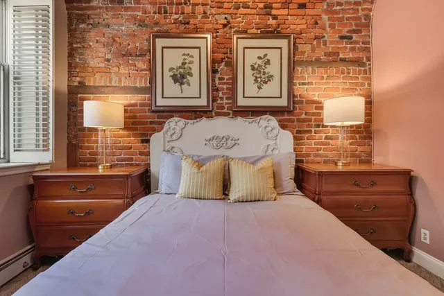 a bedroom with a bed and wall painting