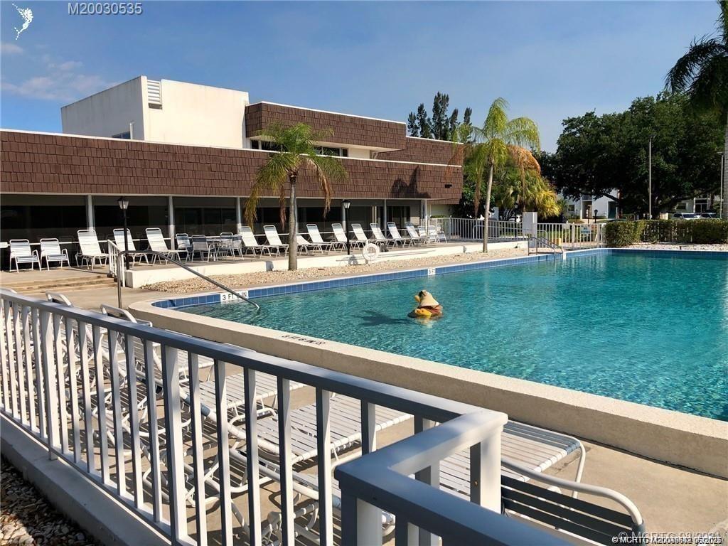 1225 Northwest 21st Street, Unit 353509 Stuart, FL 34994 - Photo 14 of 15 a view of a house with a yard