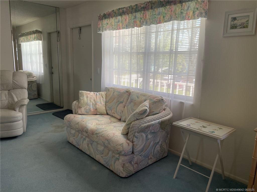 1225 Northwest 21st Street, Unit 353509 Stuart, FL 34994 - Photo 5 of 15 a living room with furniture and a window