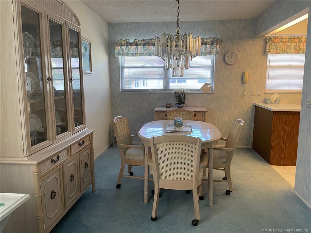 1225 Northwest 21st Street, Unit 353509 Stuart, FL 34994 - Photo 6 of 15 a dining room with furniture and window