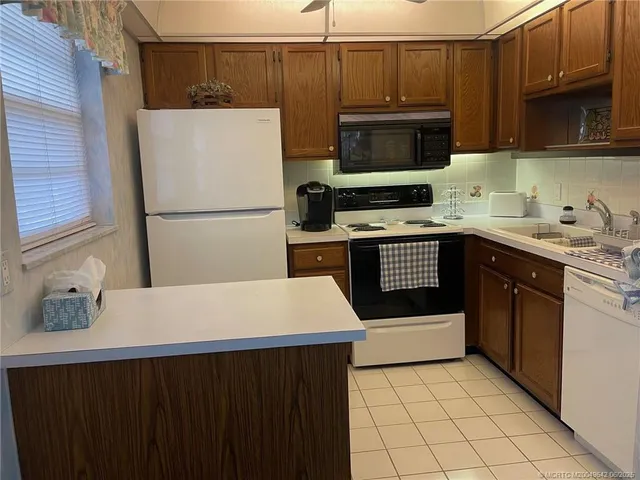 a kitchen with a sink appliances and cabinets