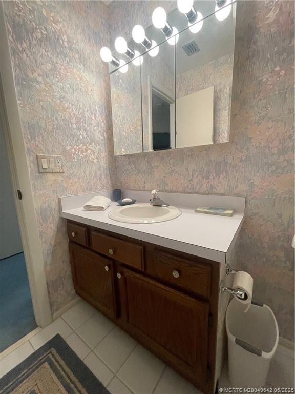 1225 Northwest 21st Street, Unit 353509 Stuart, FL 34994 - Photo 9 of 15 a bathroom with a sink double vanity and a mirror