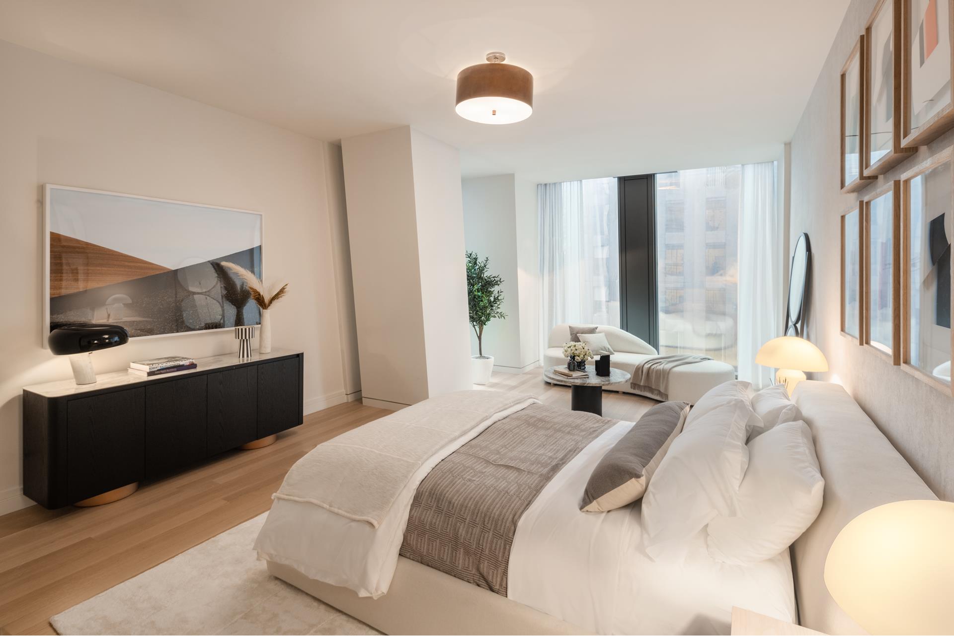 53 West 53rd Street, Unit 34C Manhattan, NY 10019 - Photo 9 of 15 a bedroom with a bed and a flat screen tv