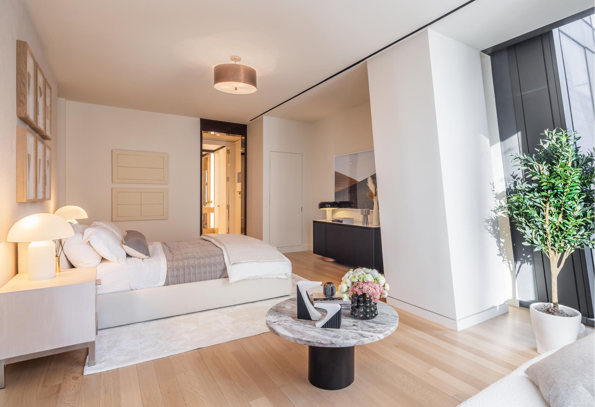 53 West 53rd Street, Unit 34C Manhattan, NY 10019 - Photo 10 of 15 a living room with furniture and flowers