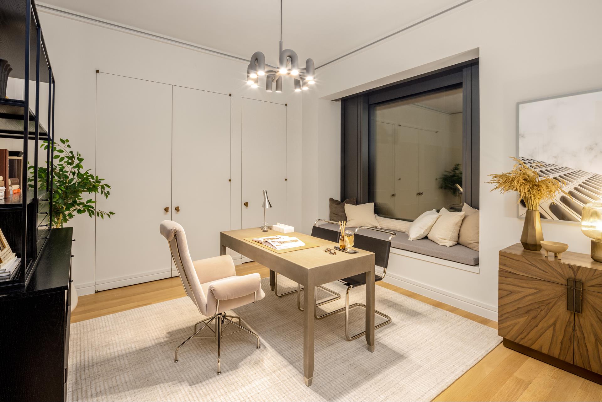53 West 53rd Street, Unit 34C Manhattan, NY 10019 - Photo 11 of 15 a living room with furniture and a chandelier