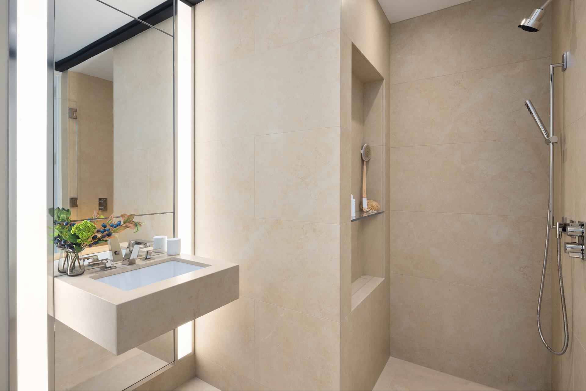 53 West 53rd Street, Unit 34C Manhattan, NY 10019 - Photo 12 of 15 a bathroom with a sink and a mirror