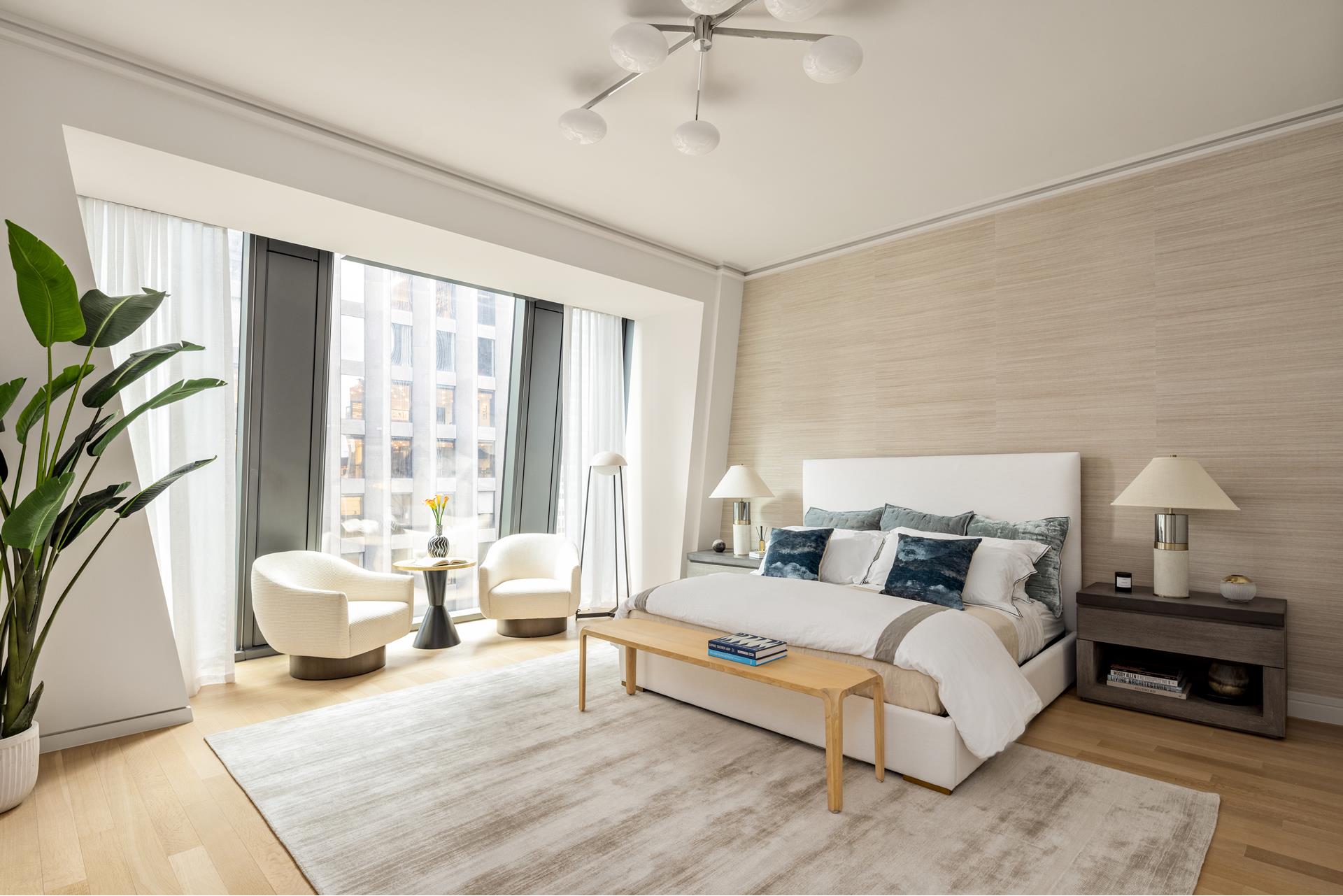53 West 53rd Street, Unit 34C Manhattan, NY 10019 - Photo 6 of 15 a spacious bedroom with a bed couch and a large window
