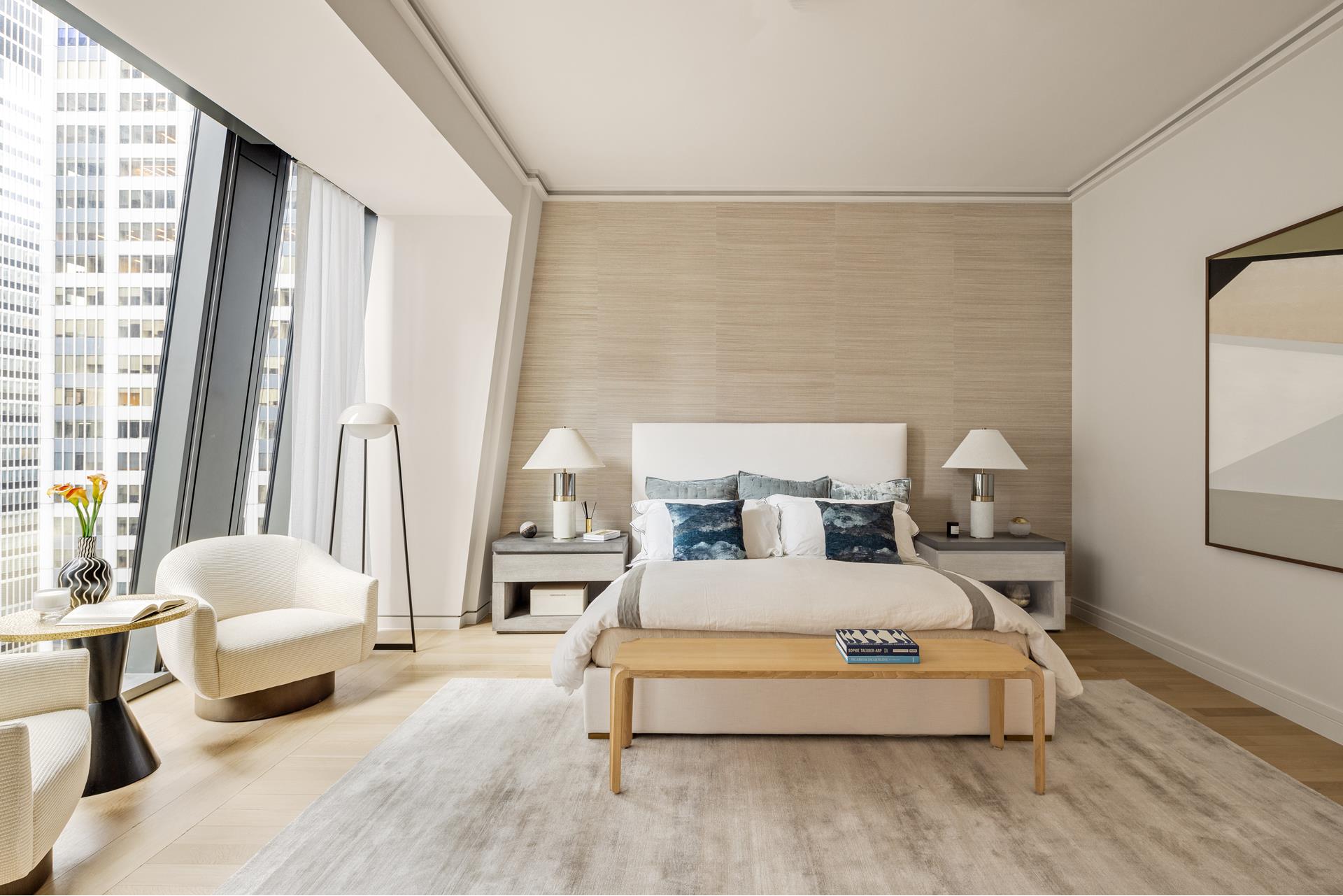 53 West 53rd Street, Unit 34C Manhattan, NY 10019 - Photo 7 of 15 a bedroom with a bed couch and a large window