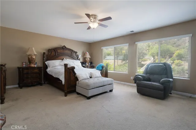 a bedroom with furniture and a large window