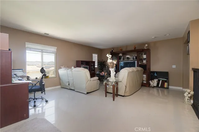 a living room with furniture a dining table and a large window