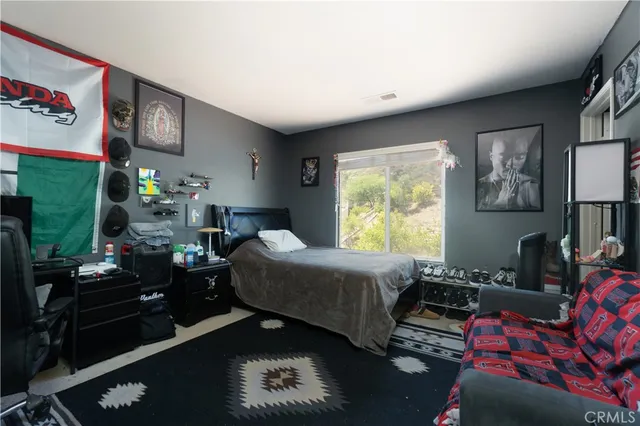 a bedroom with furniture and a window