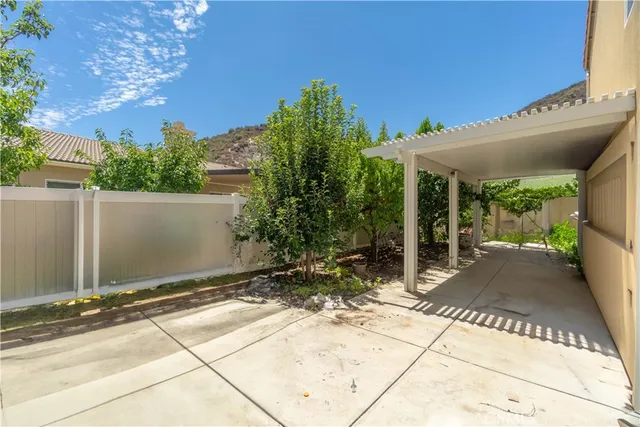 a view of a patio with table and chairs and potted plants