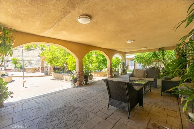 a view of a swimming pool with lawn chairs and a large window