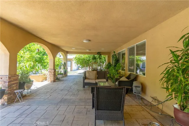 a view of a patio with couches and potted plants