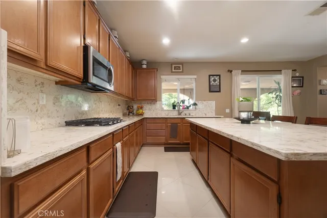 a kitchen with stainless steel appliances granite countertop wooden cabinets a sink and dishwasher