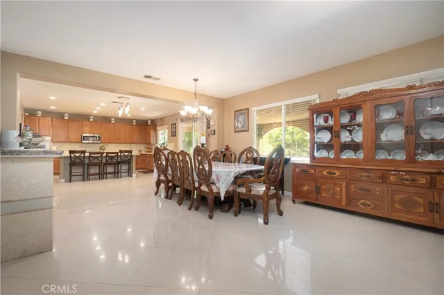 a large room with lots of wooden furniture and a chandelier