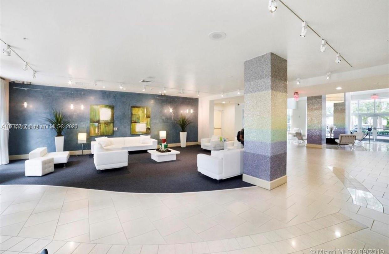 2000 North Bayshore Drive, Unit 407 Miami, FL 33137 - Photo 17 of 19 a living room with couches and kitchen view with wooden floor