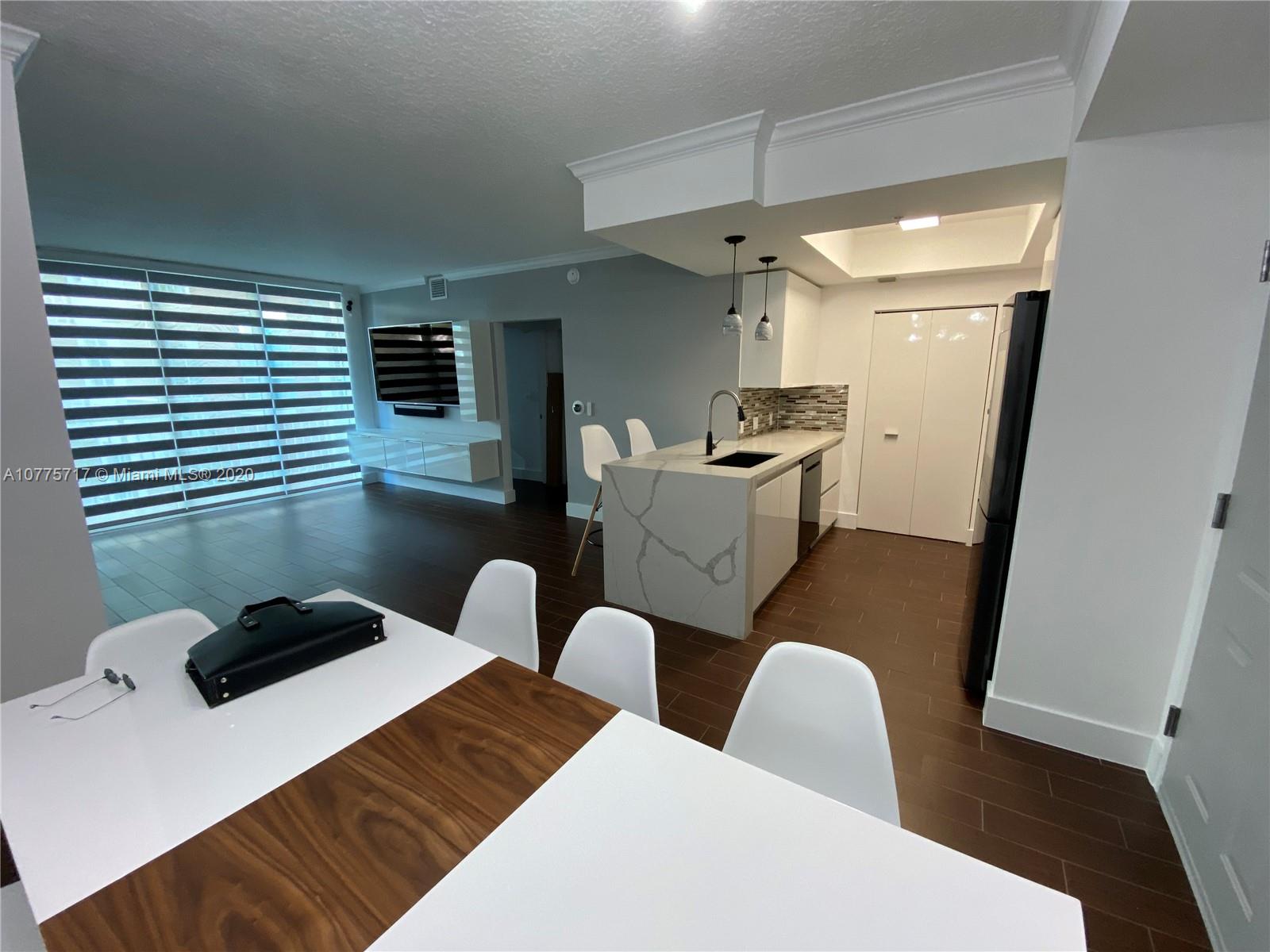 2000 North Bayshore Drive, Unit 407 Miami, FL 33137 - Photo 2 of 19 a bedroom with furniture and a window