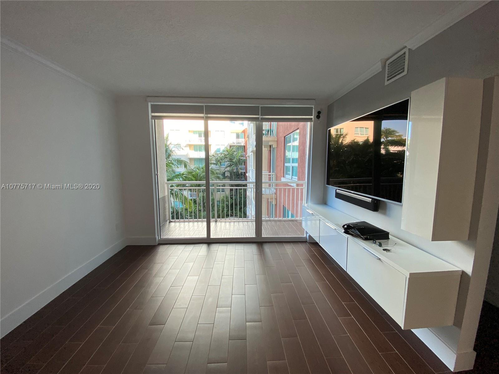2000 North Bayshore Drive, Unit 407 Miami, FL 33137 - Photo 3 of 19 a room with window and flat screen tv