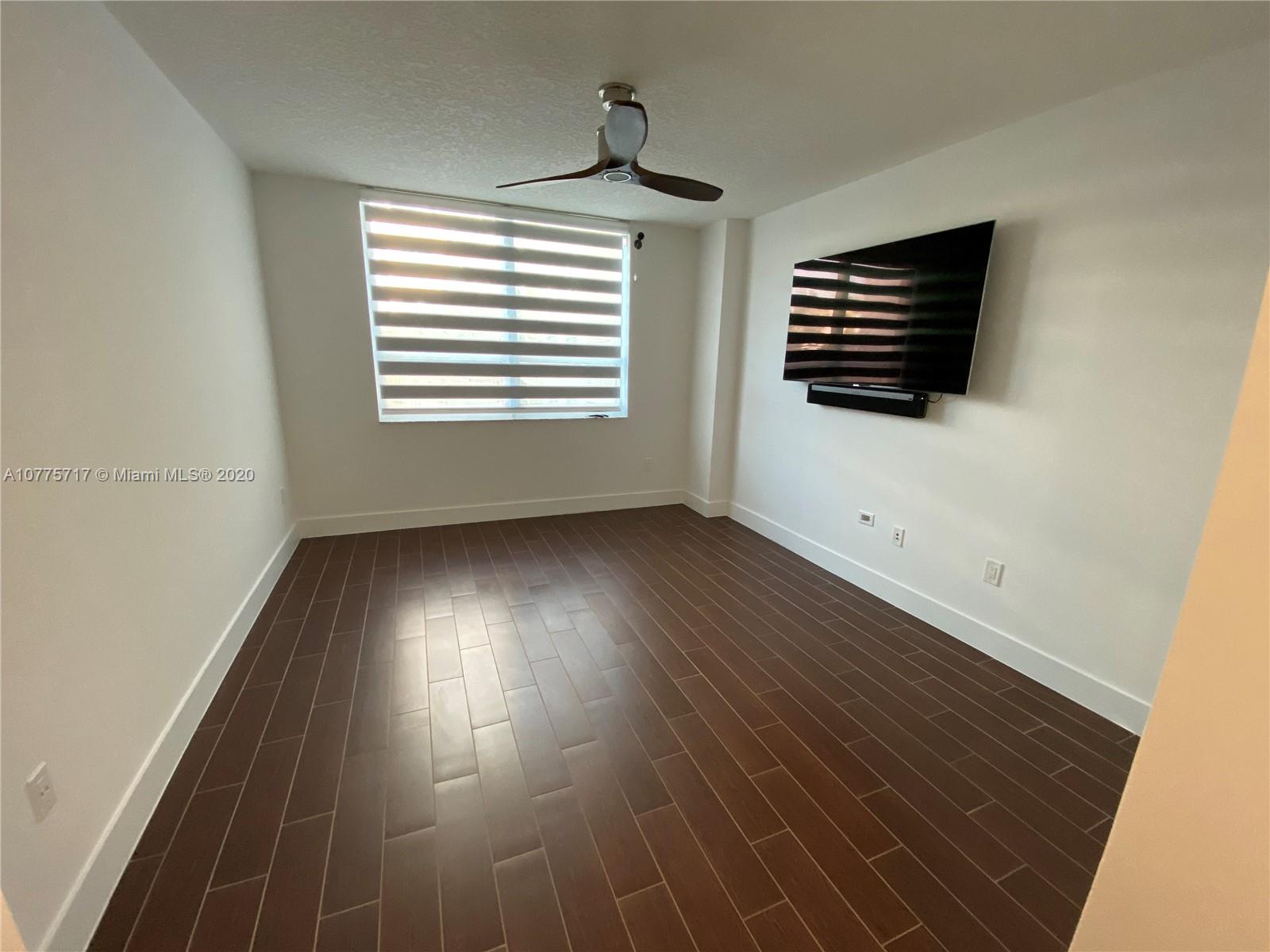 2000 North Bayshore Drive, Unit 407 Miami, FL 33137 - Photo 4 of 19 a view of an empty room with wooden floor and a window