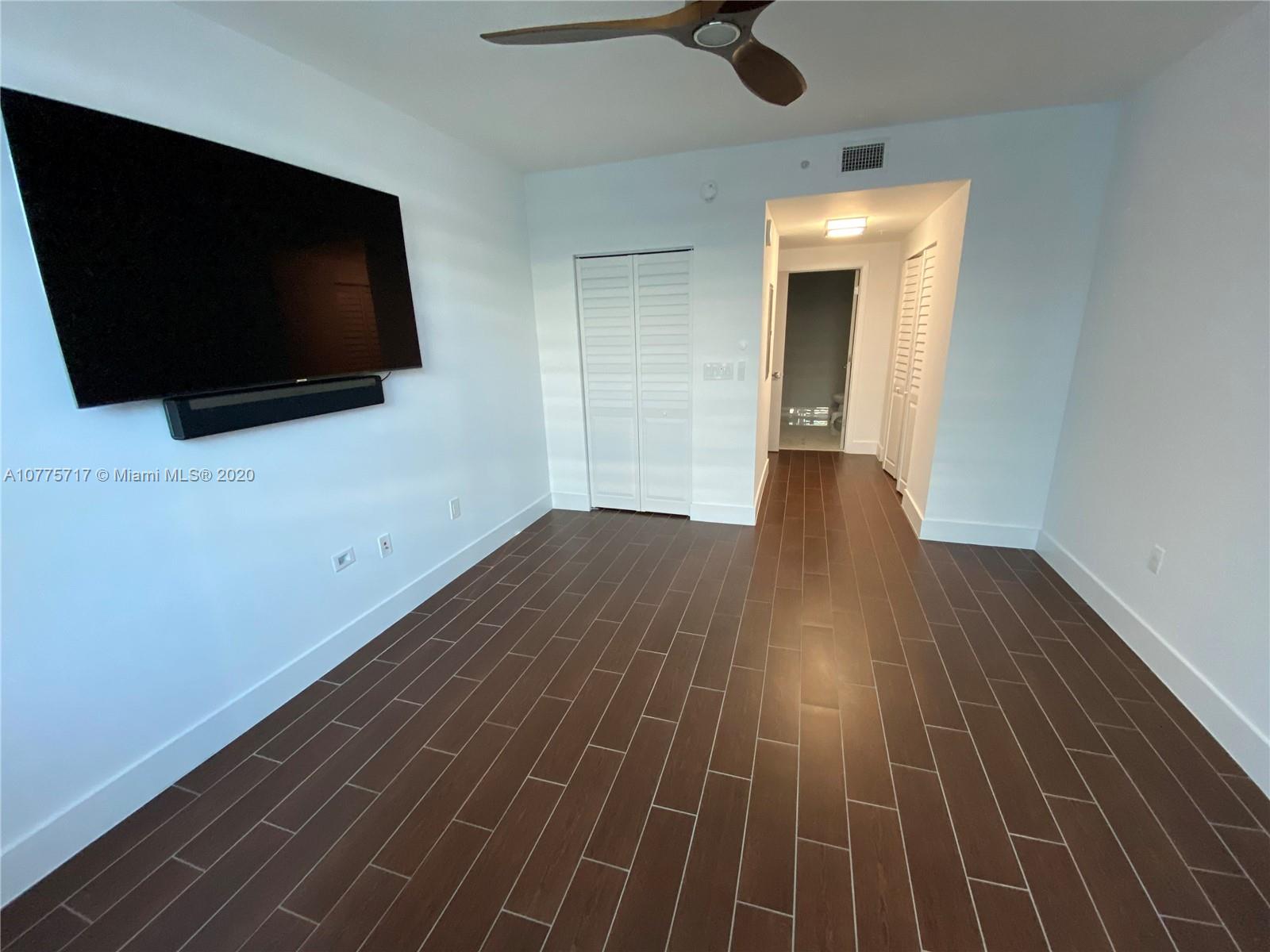2000 North Bayshore Drive, Unit 407 Miami, FL 33137 - Photo 5 of 19 a view of a room with wooden floor and windows