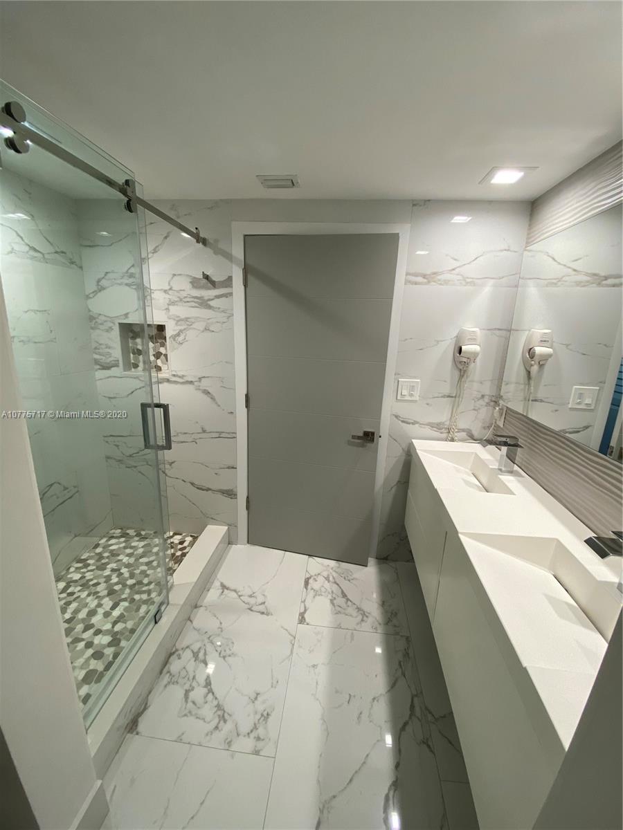 2000 North Bayshore Drive, Unit 407 Miami, FL 33137 - Photo 7 of 19 a bathroom with a sink and a shower