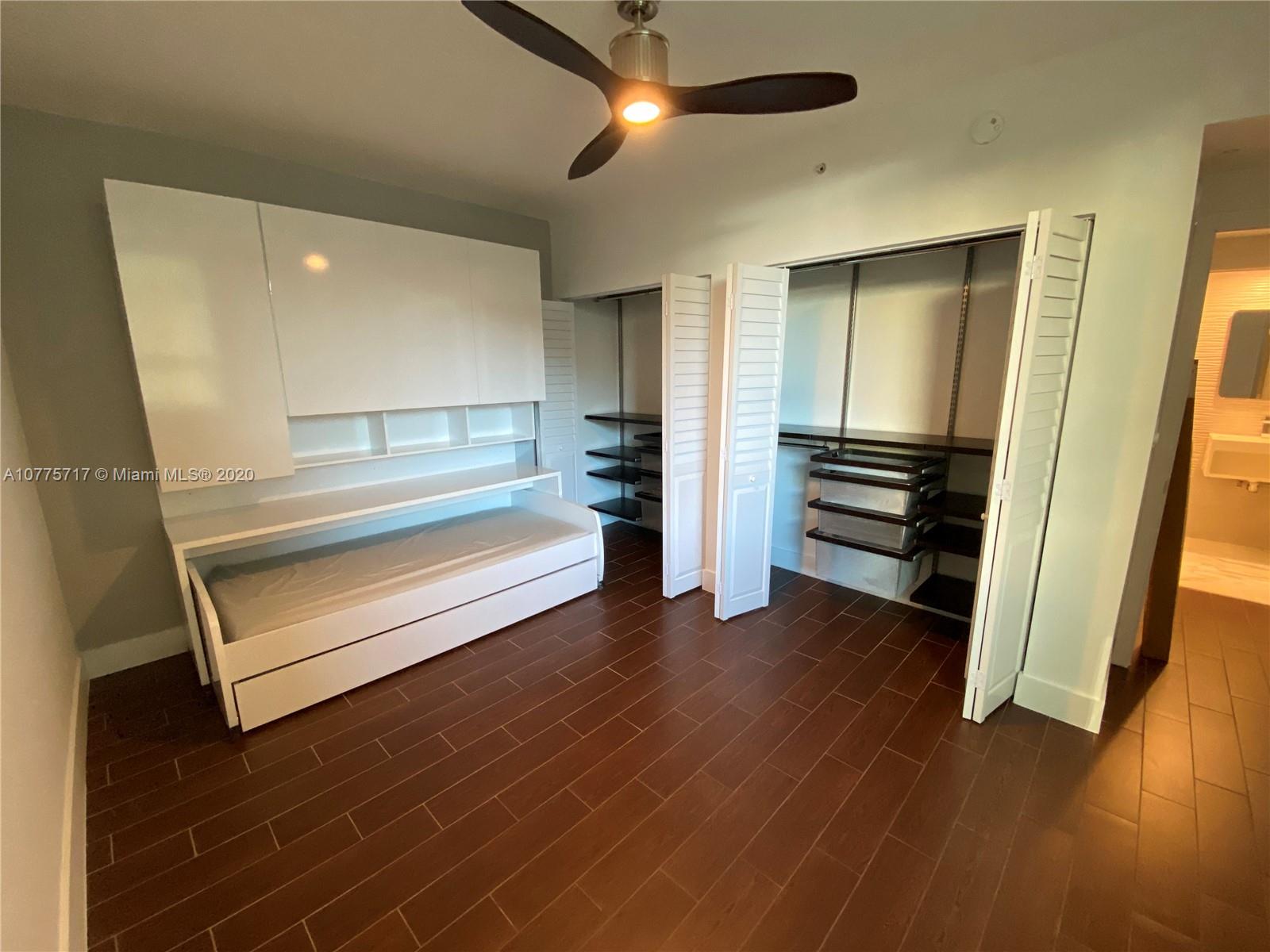 2000 North Bayshore Drive, Unit 407 Miami, FL 33137 - Photo 9 of 19 a view of a room with wooden floor staircase and a ceiling fan