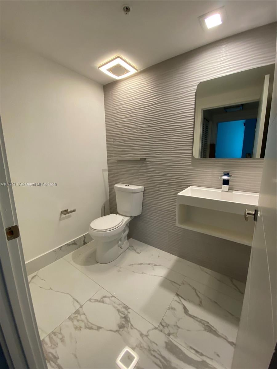 2000 North Bayshore Drive, Unit 407 Miami, FL 33137 - Photo 10 of 19 a bathroom with a sink toilet mirror and vanity