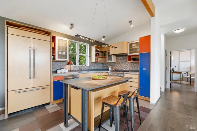 a living room with furniture potted plant and a large window