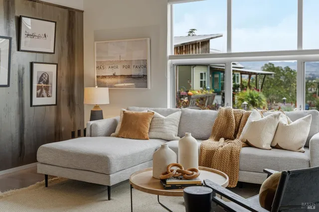 a view of a hallway with potted plants in front of door