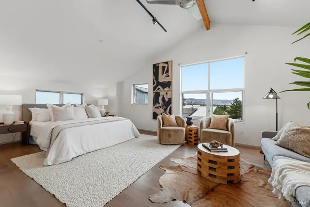 a bed sitting in a bedroom next to a window