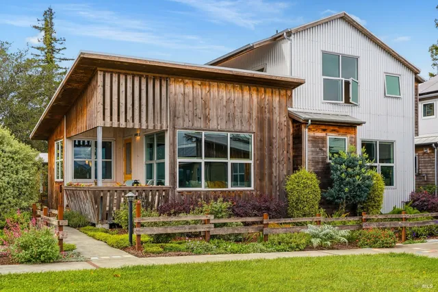 a front view of a house with a yard table and chairs