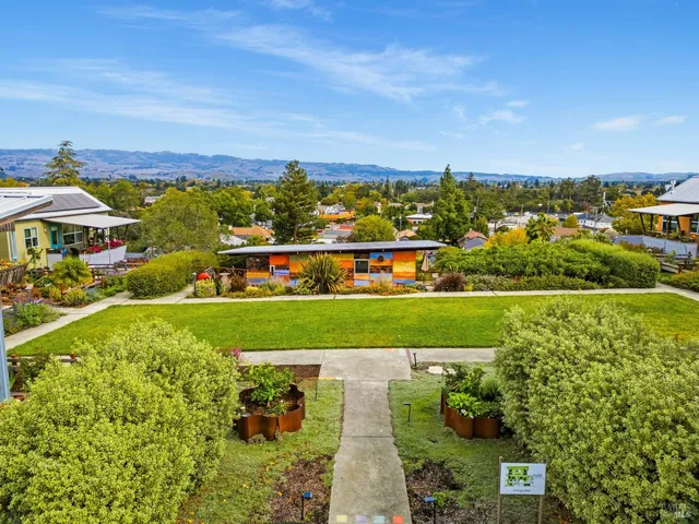 an aerial view of residential houses with outdoor space