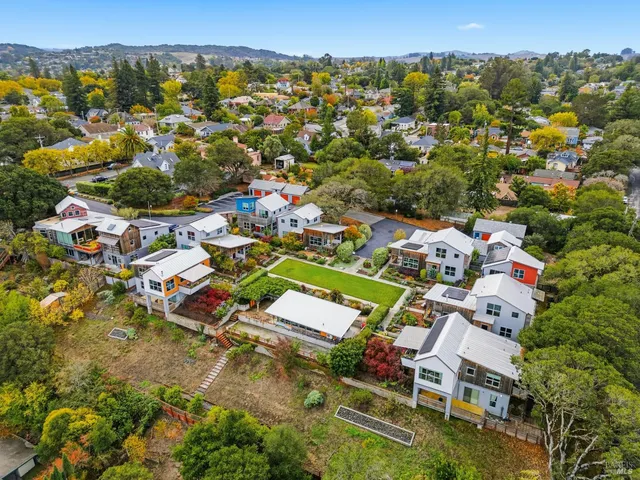 an aerial view of a house with a yard