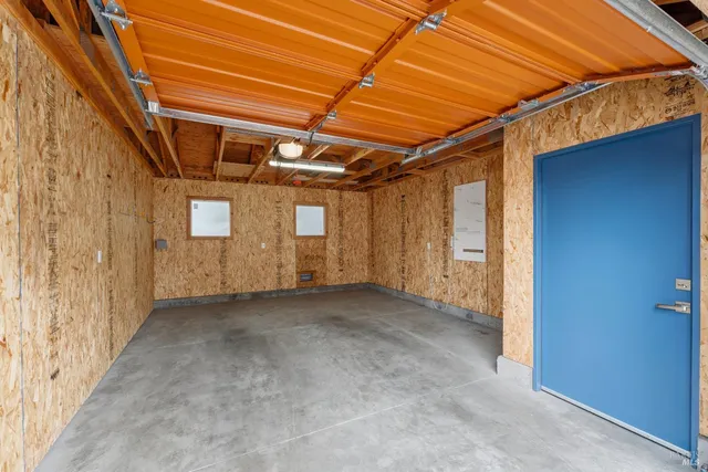 a view of a house with a yard and garage