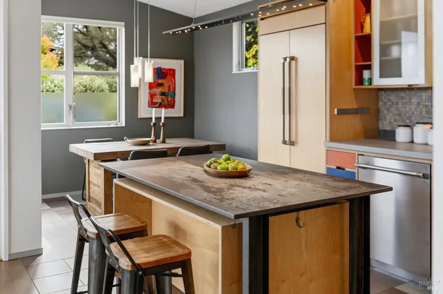 a kitchen with stainless steel appliances granite countertop a sink a stove and a wooden cabinets