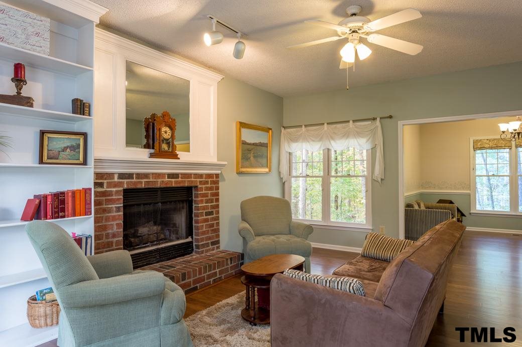 1241 Hillingdon Way Raleigh, NC 27614 - Photo 2 of 21 This Family Room is a great open space to enjoy family and friends. Large Fireplace is the focal point! Built-in Bookshelves are a great feature and provide storage and decor for this space. Views to the front and back of the home.